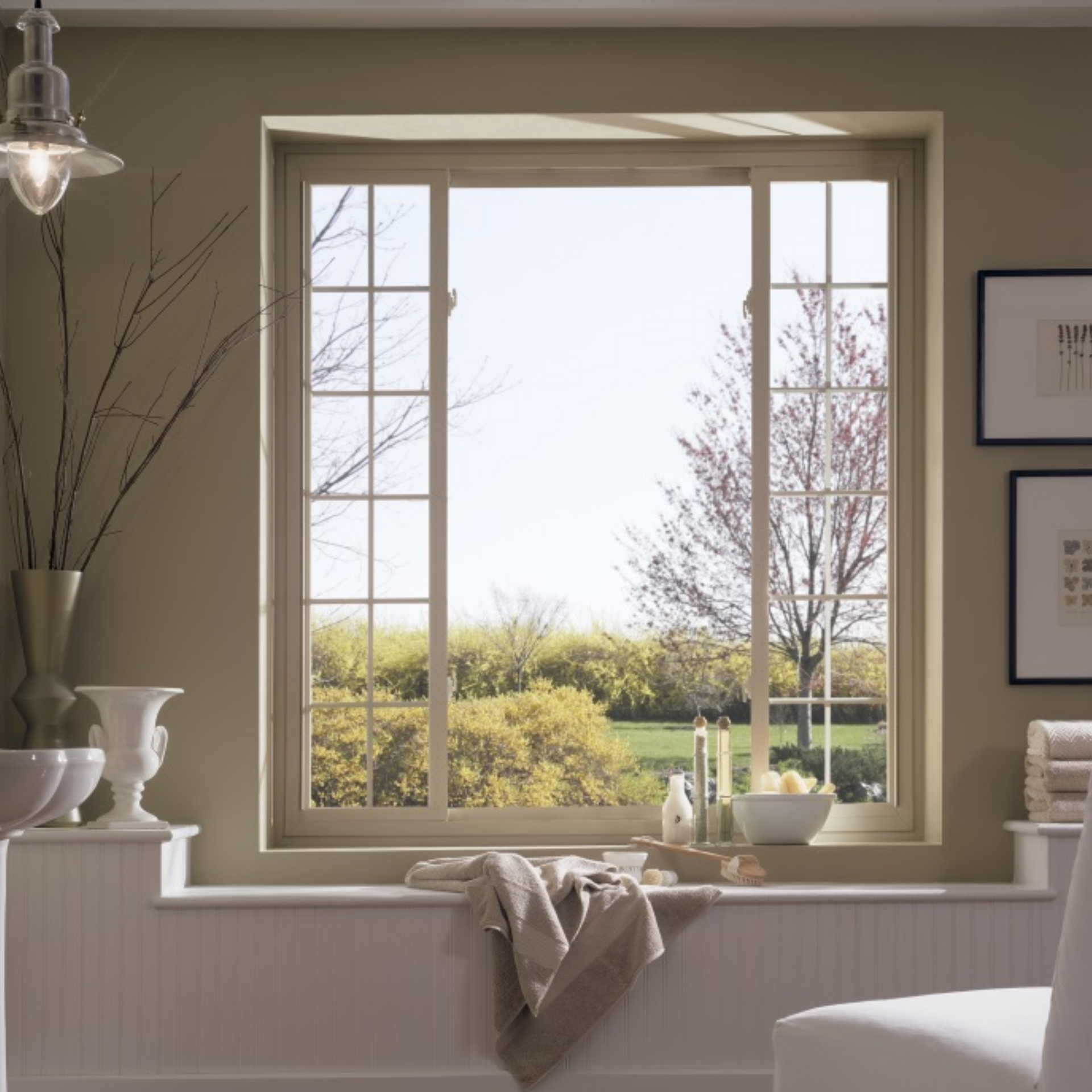 A bathroom with a large window over a bathtub