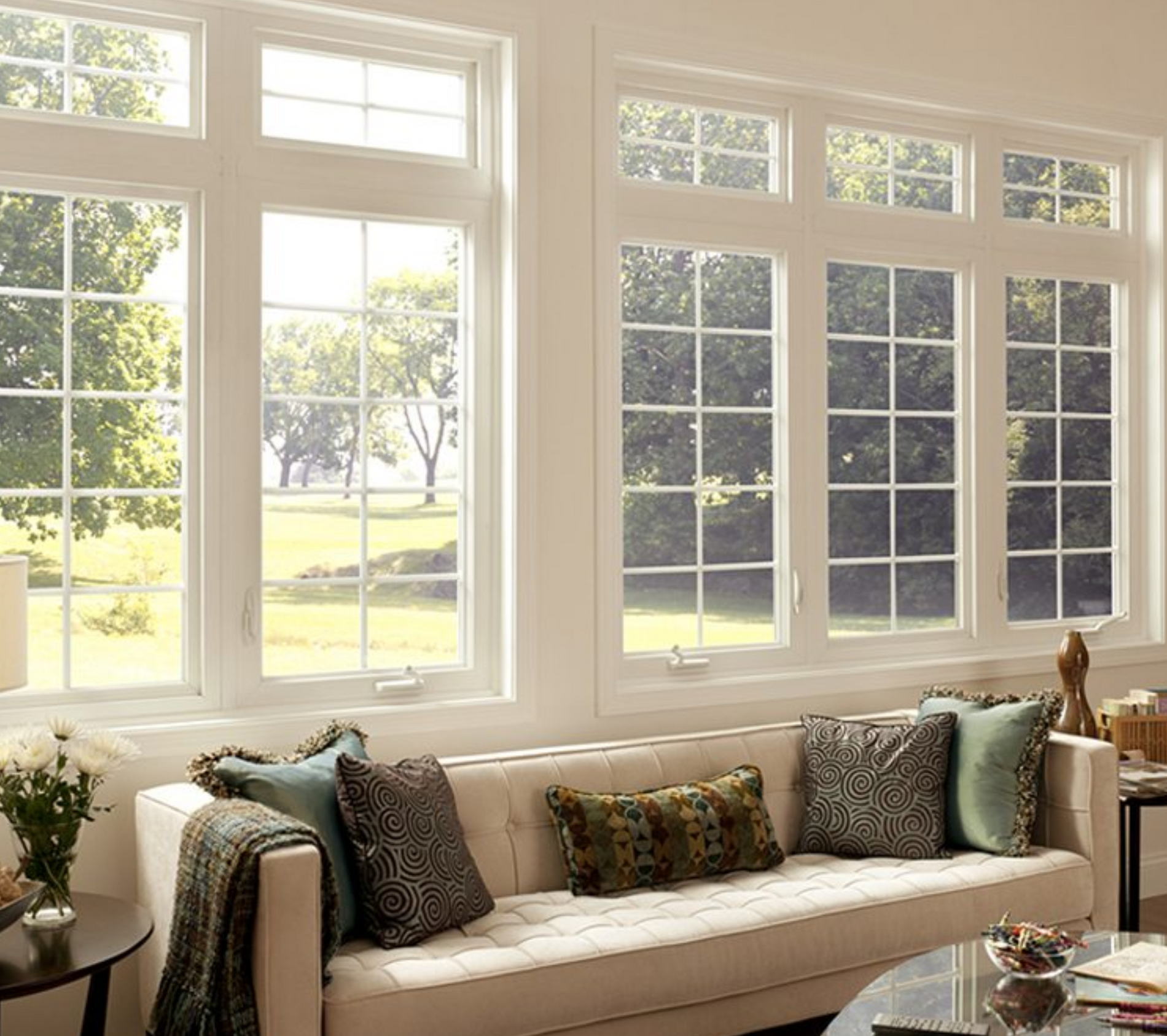 A living room with a couch and lots of windows