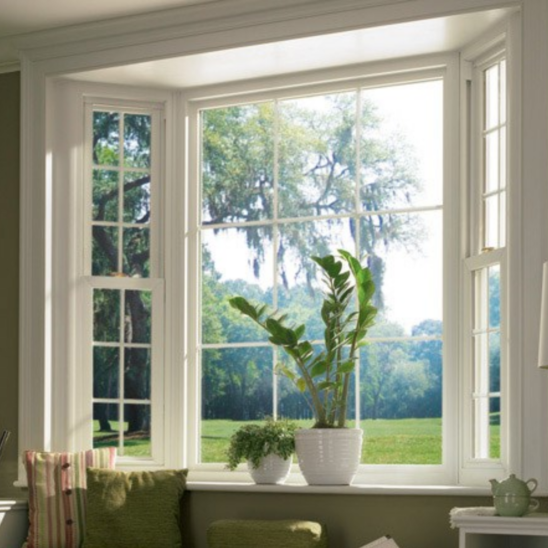 A living room with a large window and a potted plant on the window sill