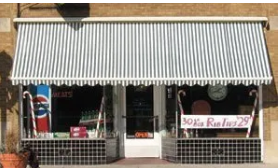 A store front with a striped awning and candy canes