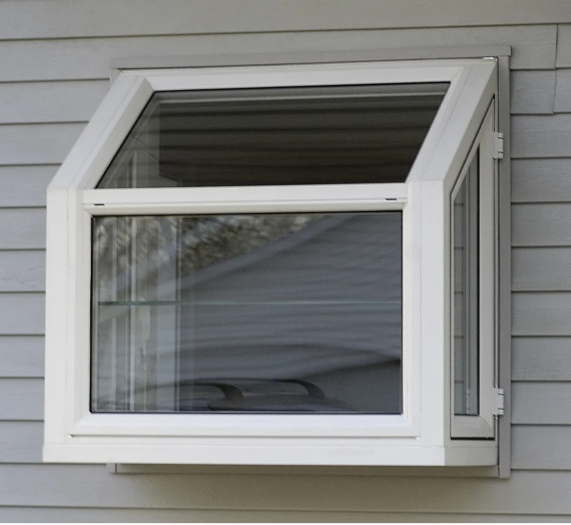 A white window on the side of a house