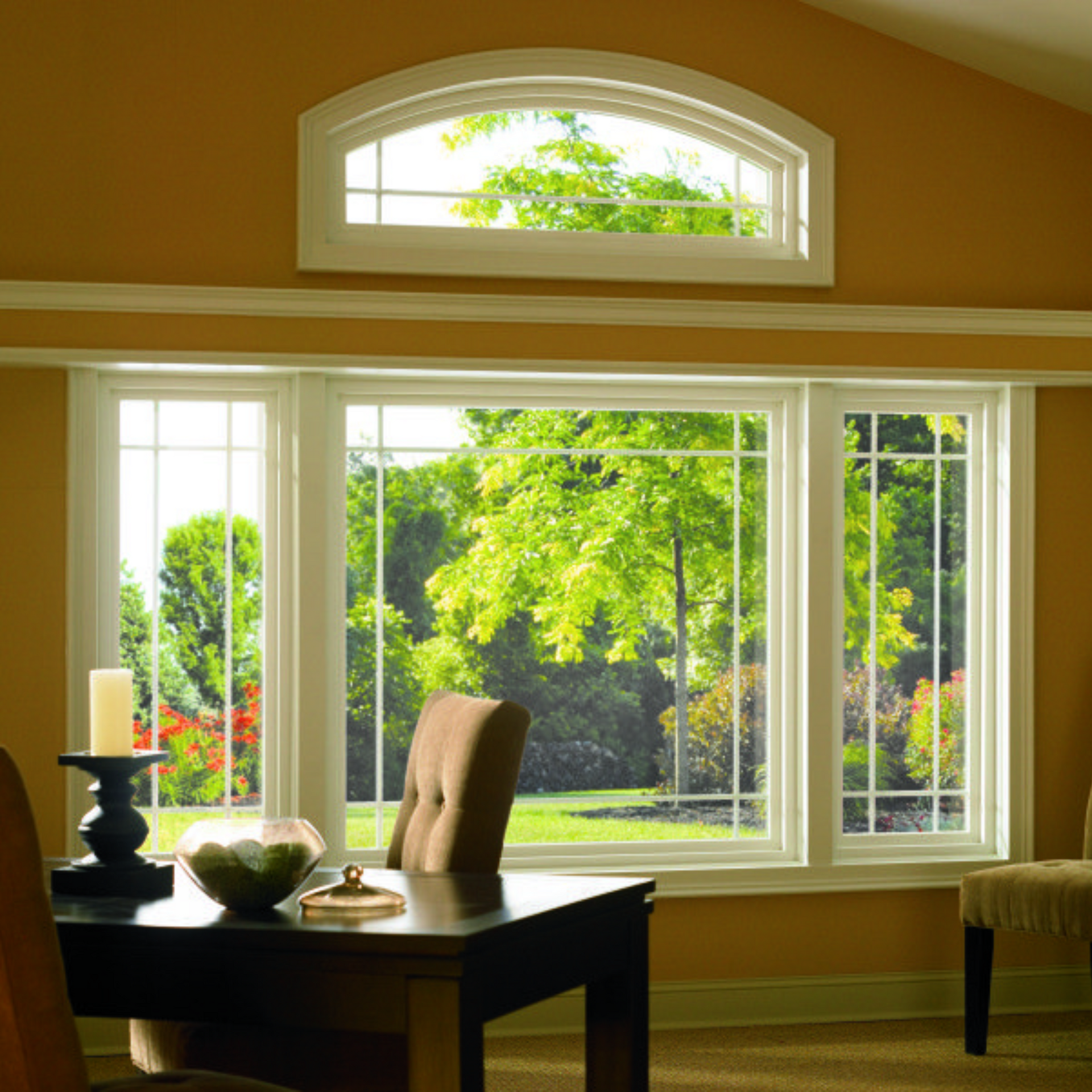 A living room with a table and chairs and a large window