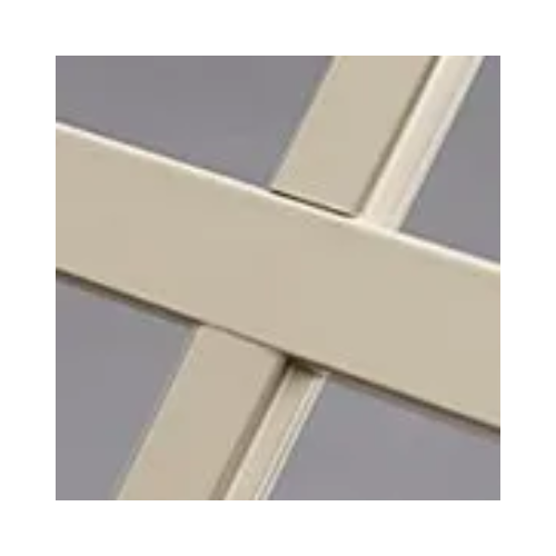 A close up of a metal cross on a gray background.