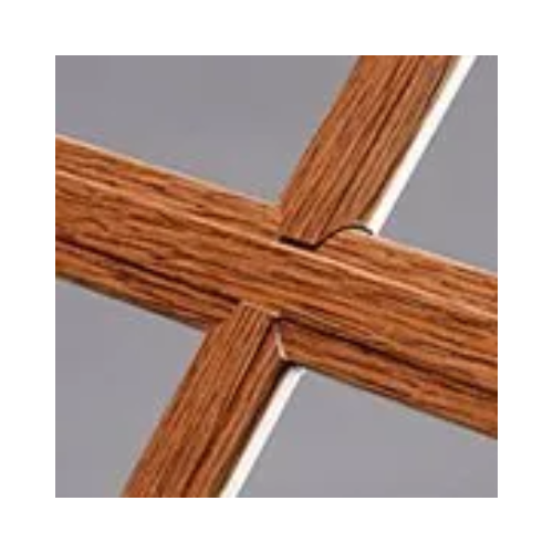 A close up of a wooden cross on a gray background.