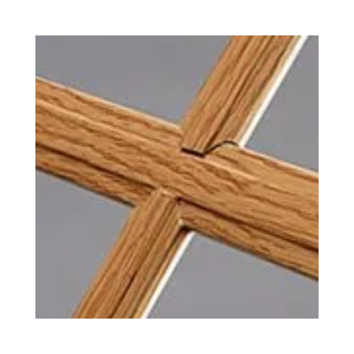 A close up of a wooden cross on a gray background.