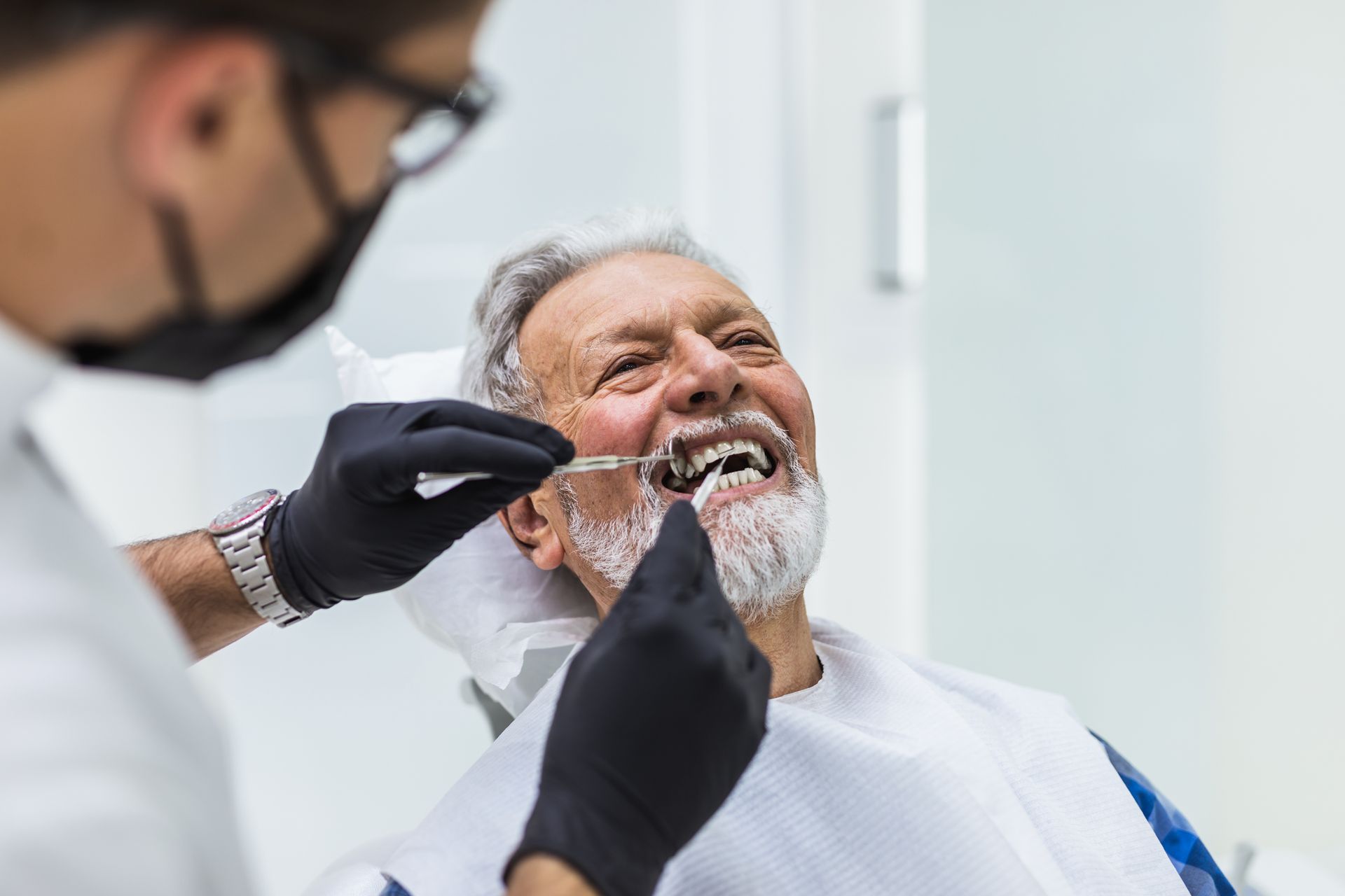 A senior man having dental treatment at the dentist's office.