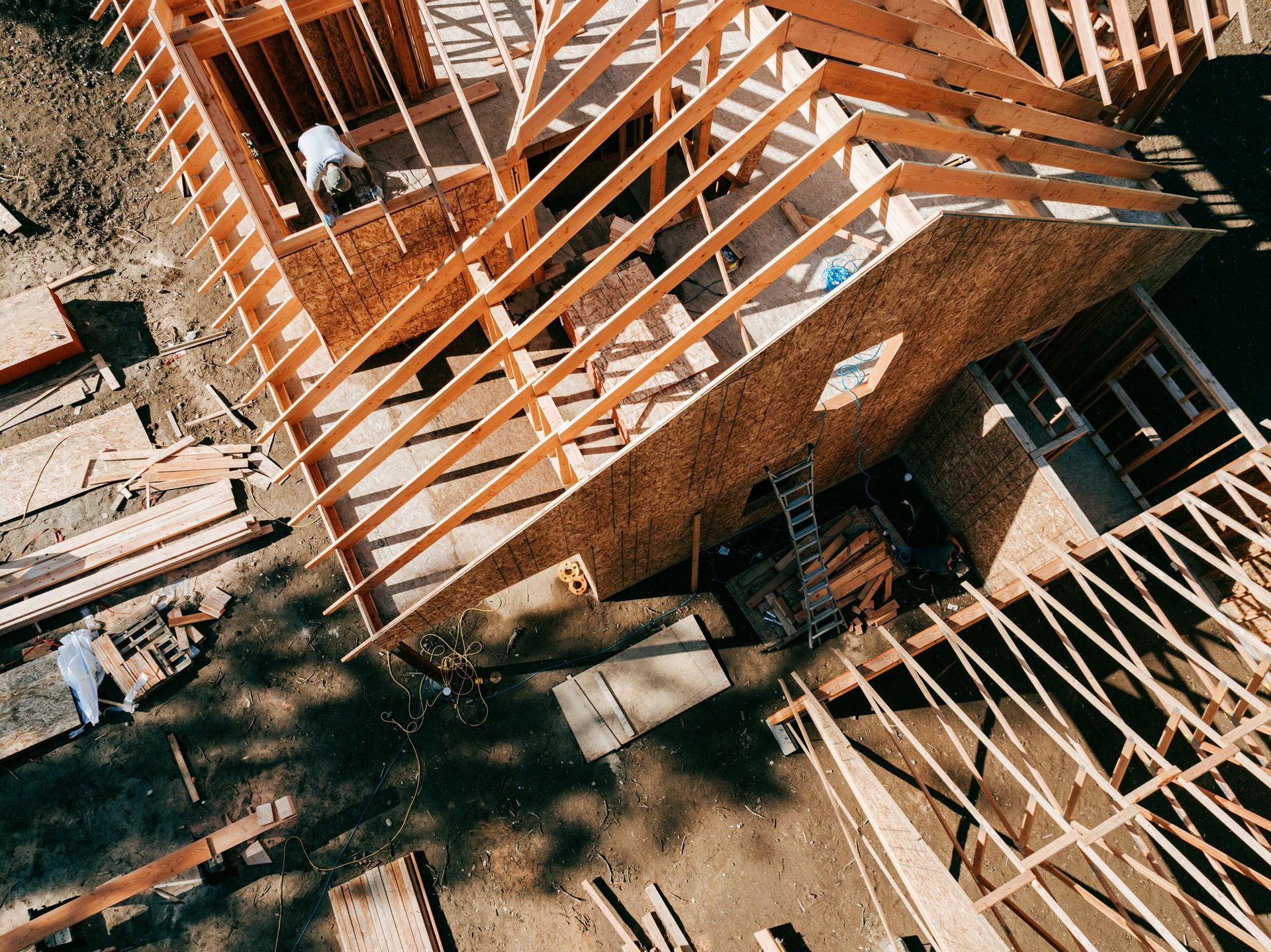 Construction crew assembling timber framing for a new home build project.