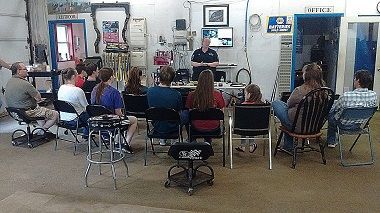 A group of people are sitting in chairs | BJ’s Automotive Diagnostic Center