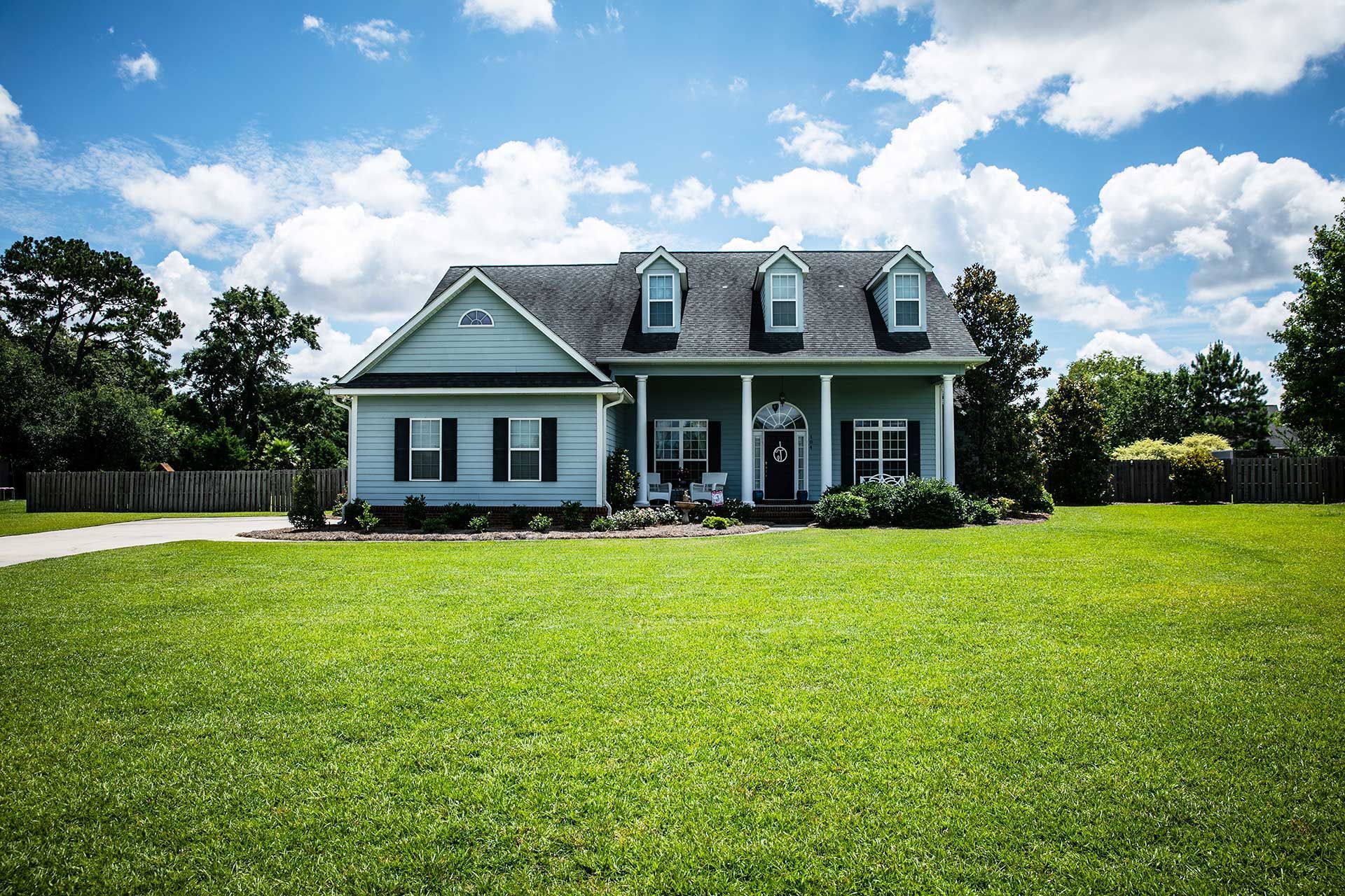Blue Traditional Siding House Home in Suburbs Front Facing with Curb Appeal 
