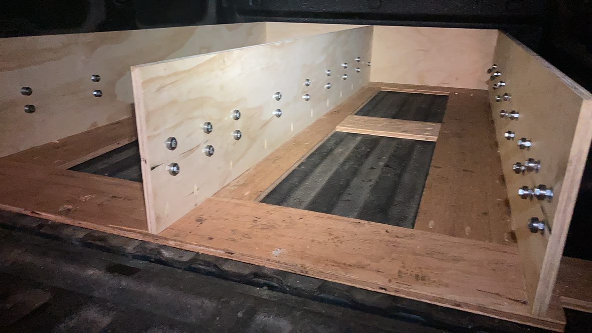 Wooden storage unit with two large compartments and metal fasteners on the sides