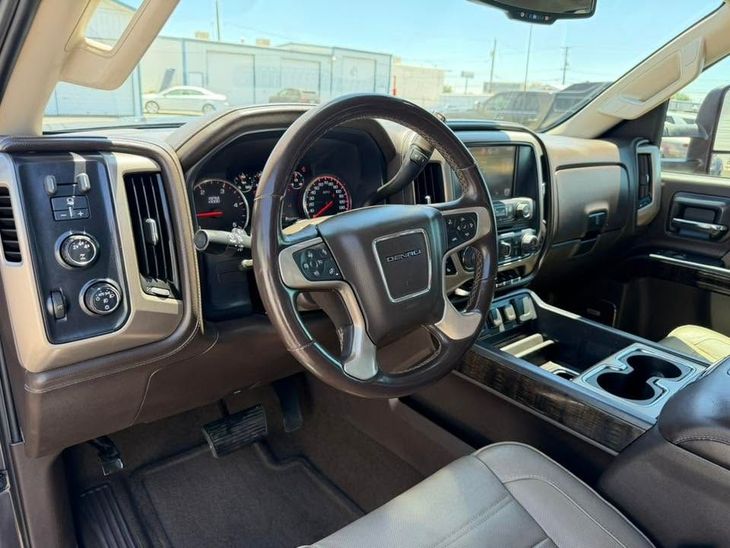 Brown truck interior with steering wheel, dashboard, and center console, viewed from the driver’s seat