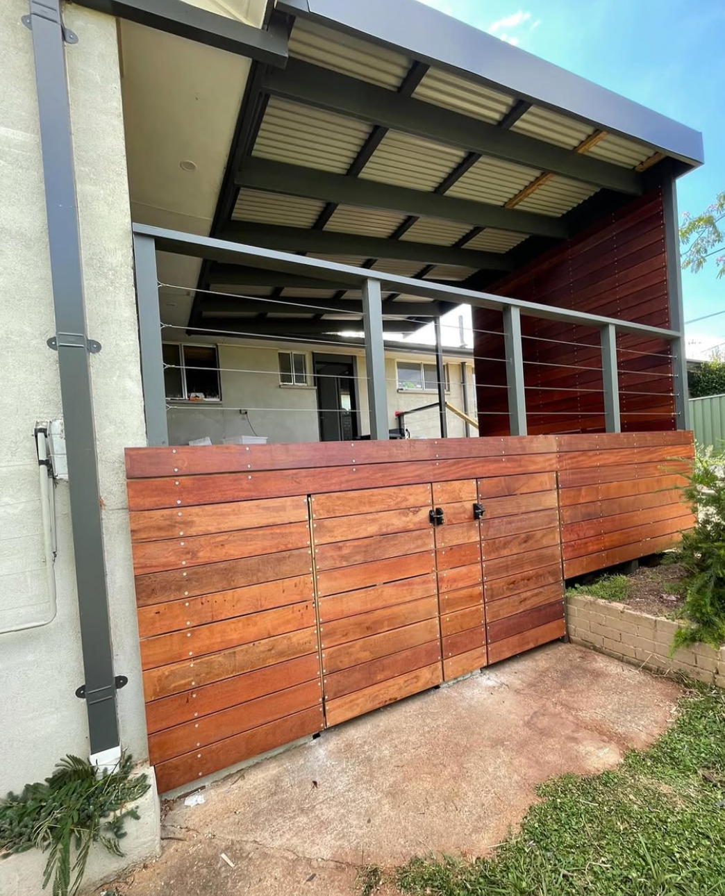 A house with a wooden deck and a wooden gate