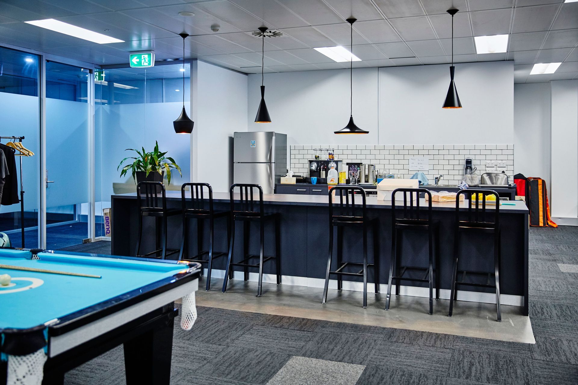 There is a pool table in the middle of the room.