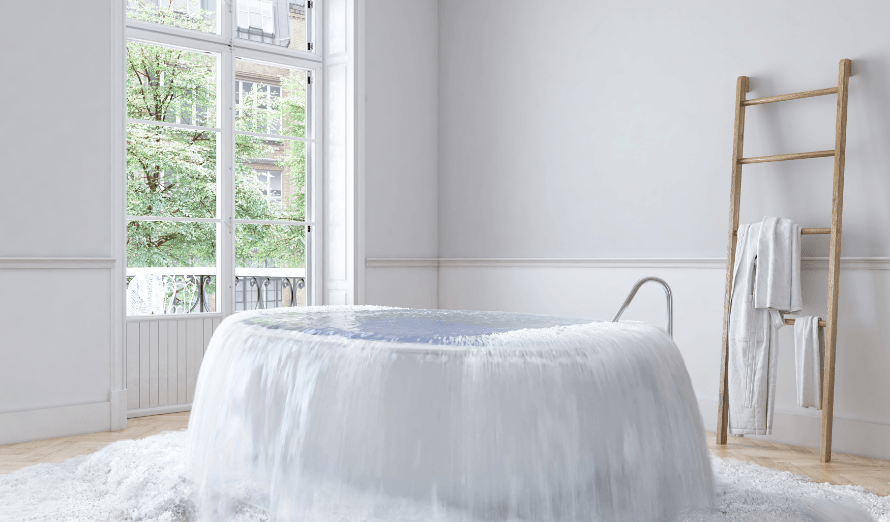 A bathroom with a bathtub filled with water that looks like a waterfall.