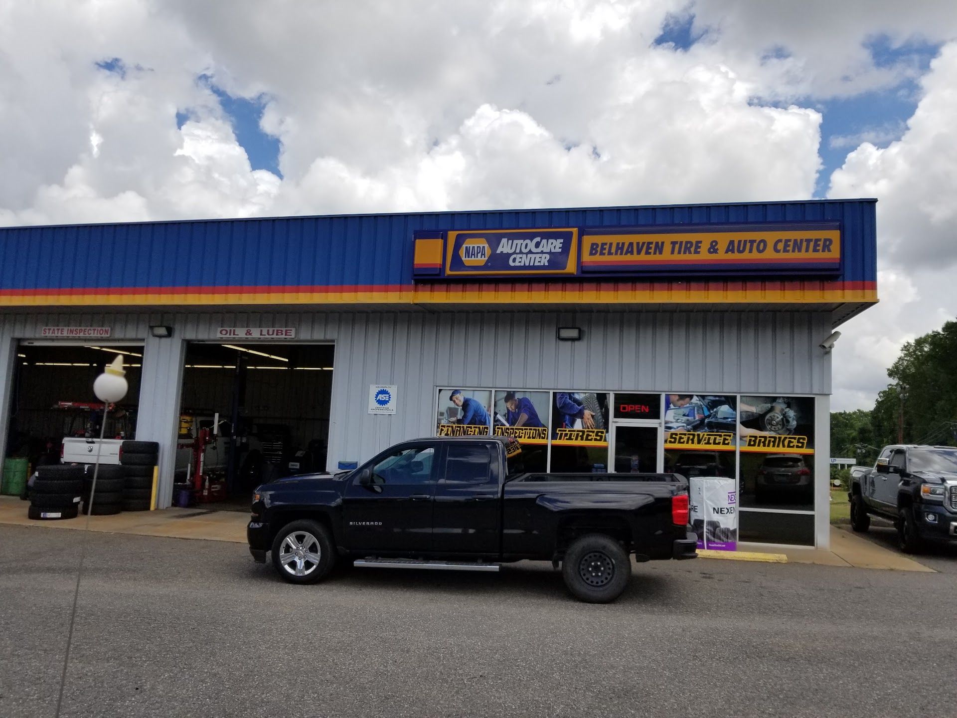 Auto Repair Shop Exterior With Customer Truck In Front | Belhaven Tire And Auto