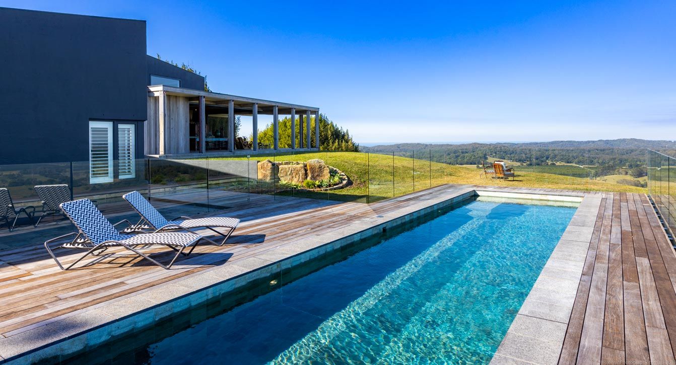 Lap Pool With Sun Beds on Deck — Quality Swimming Pools in Coolangatta, QLD