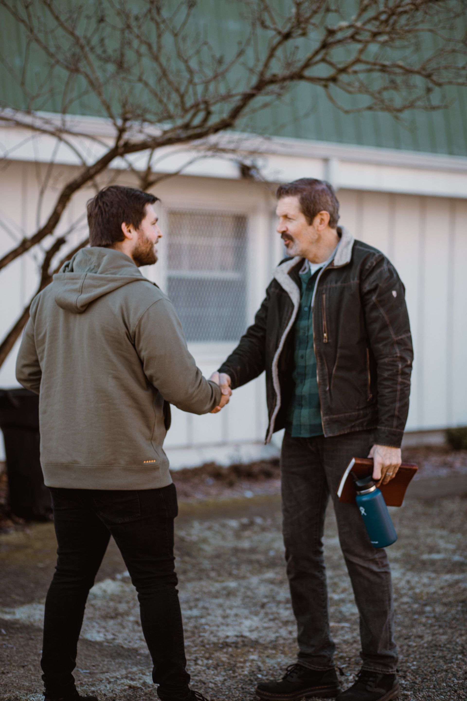 Church greeter shaking hands with visiting congregate