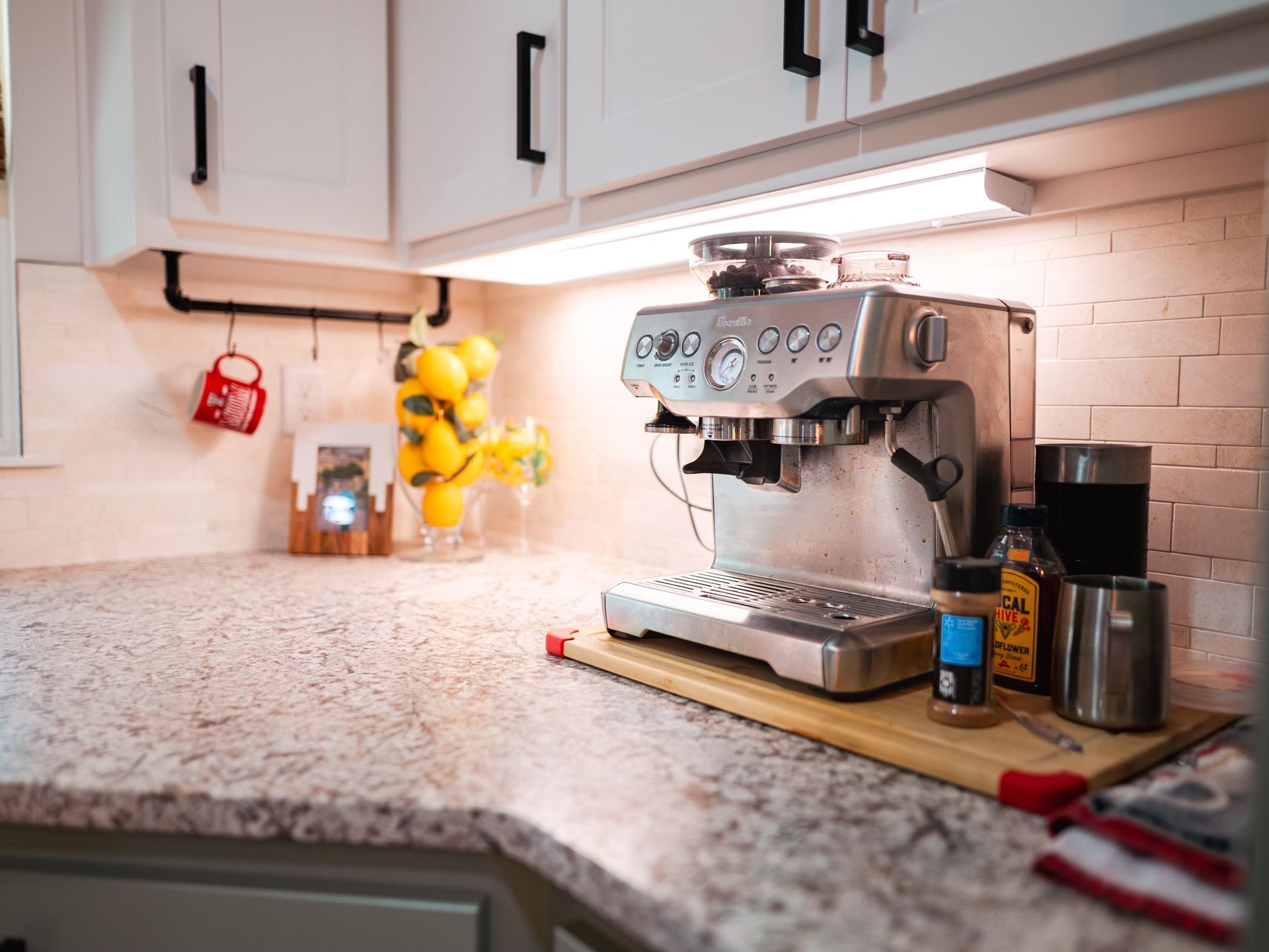 A coffee maker is sitting on a counter in a kitchen.