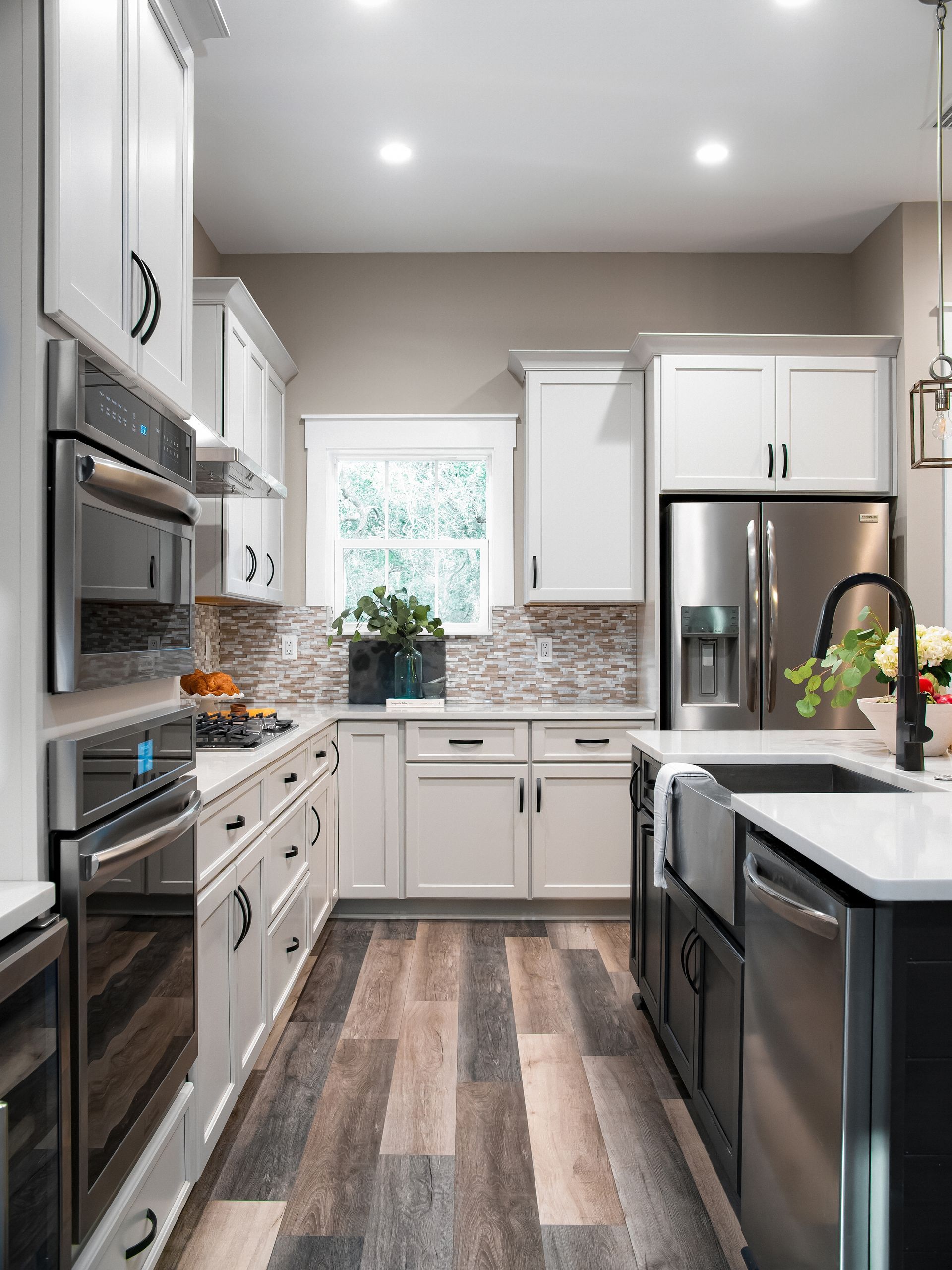 A kitchen with purple and white cabinets and a rug on the floor.