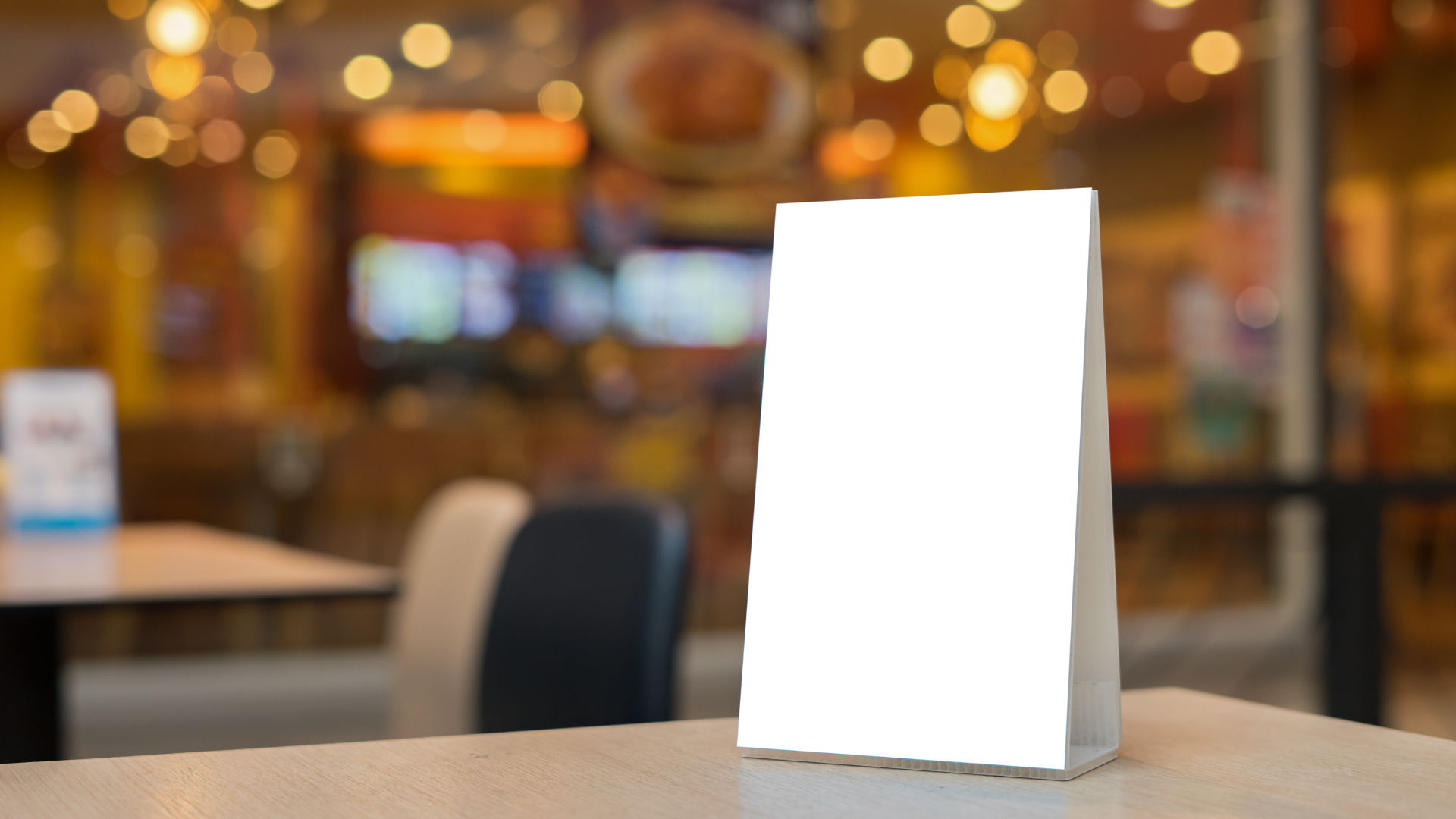 a sign is sitting on a table in a restaurant