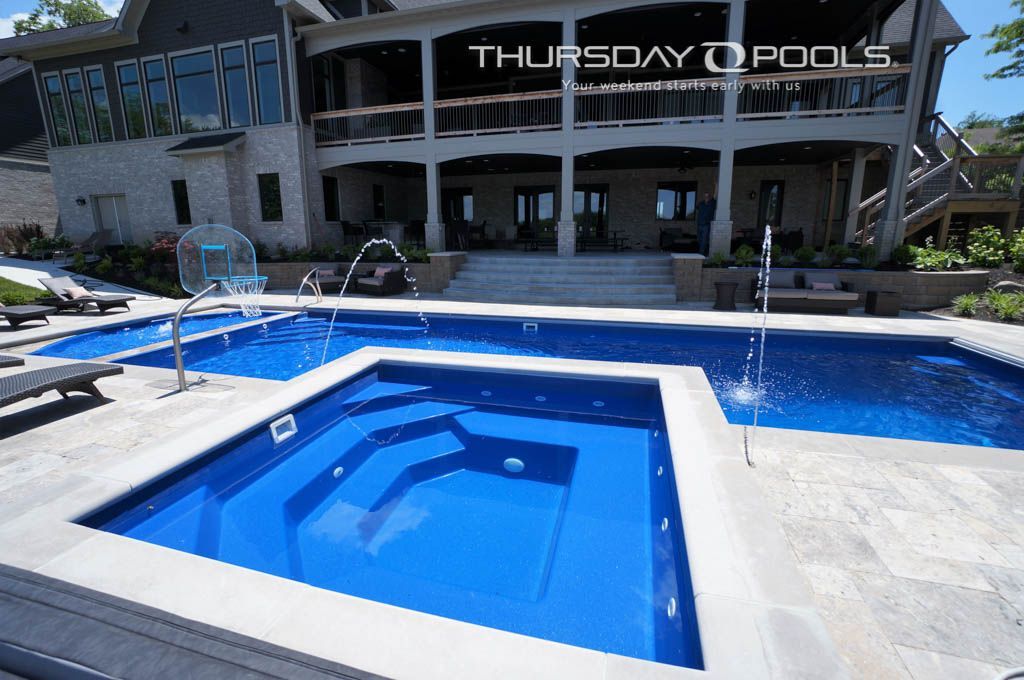 A large house with a large swimming pool in front of it