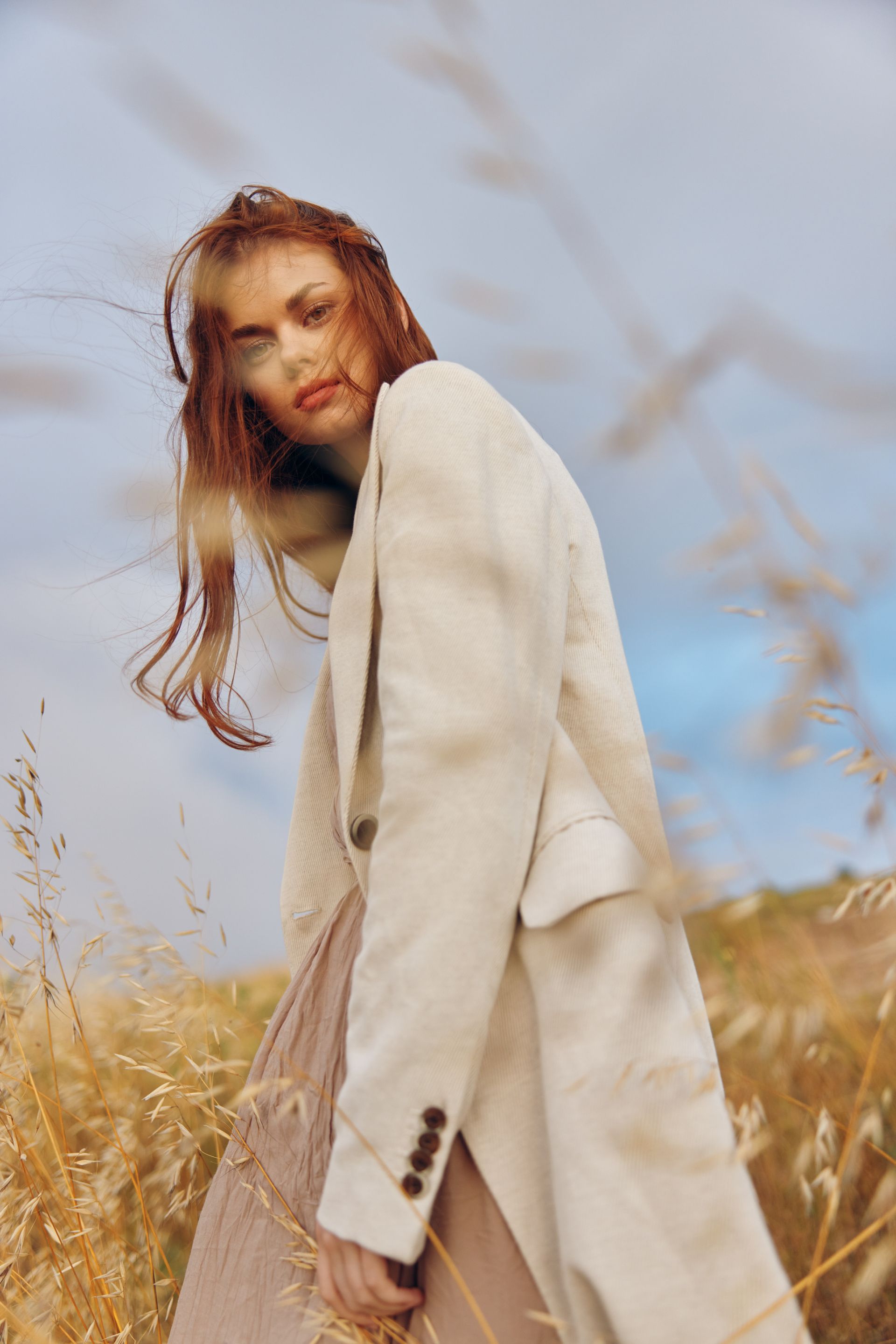 Model Eliza in a field, ready for anything during her shoot