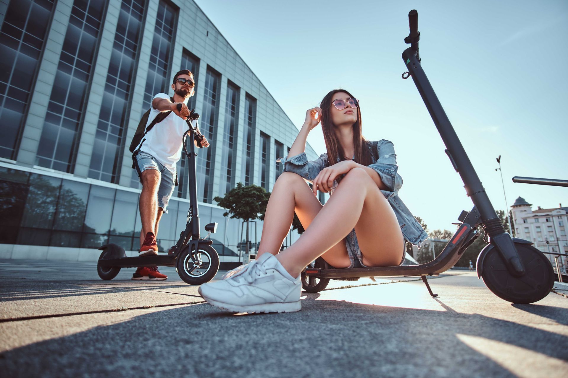 A picture taken by our photographer of a man and his pretty girlfriend on their scooters downdown 