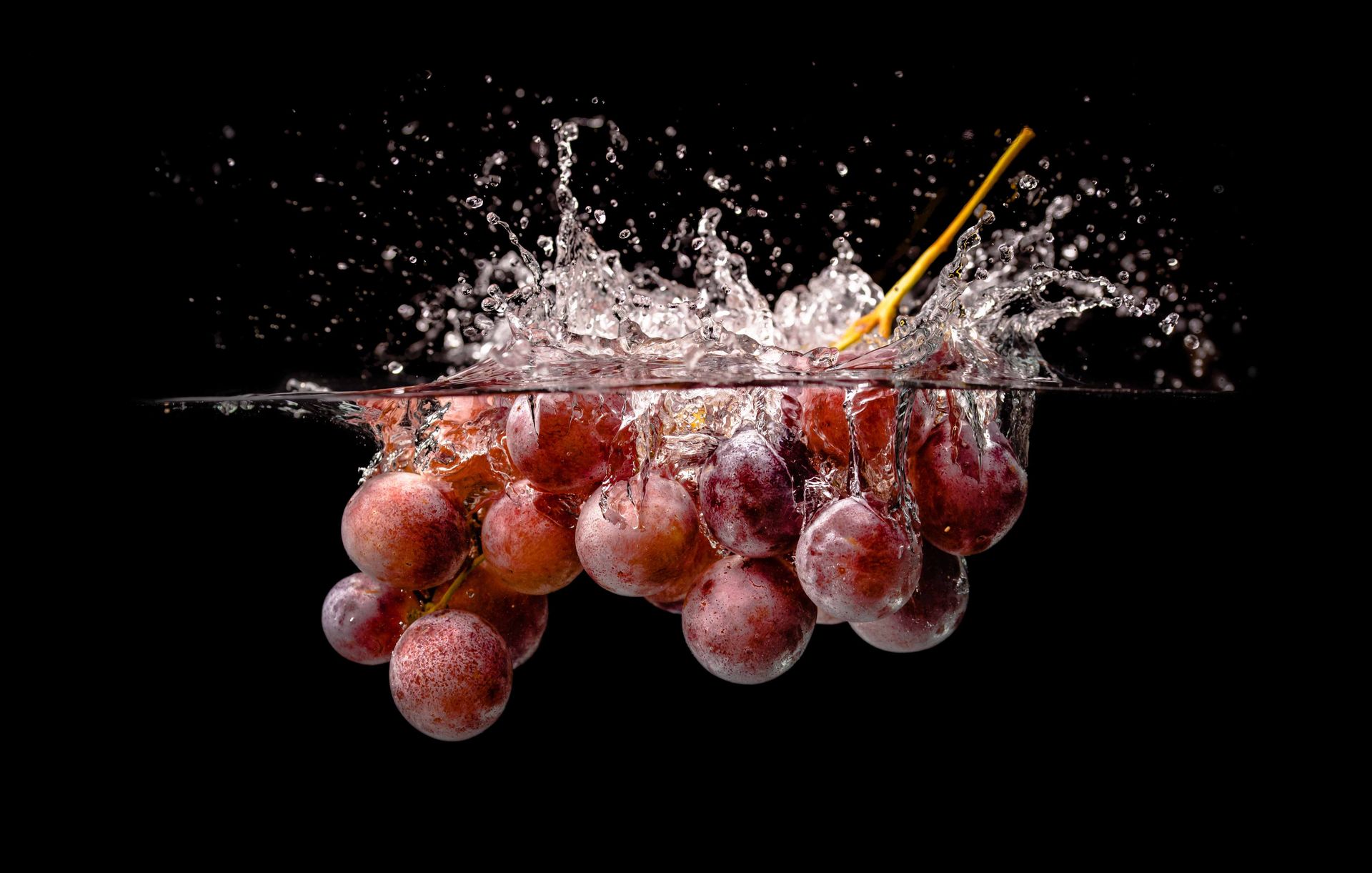 Professional Photograph of Grapes Splashing in Water