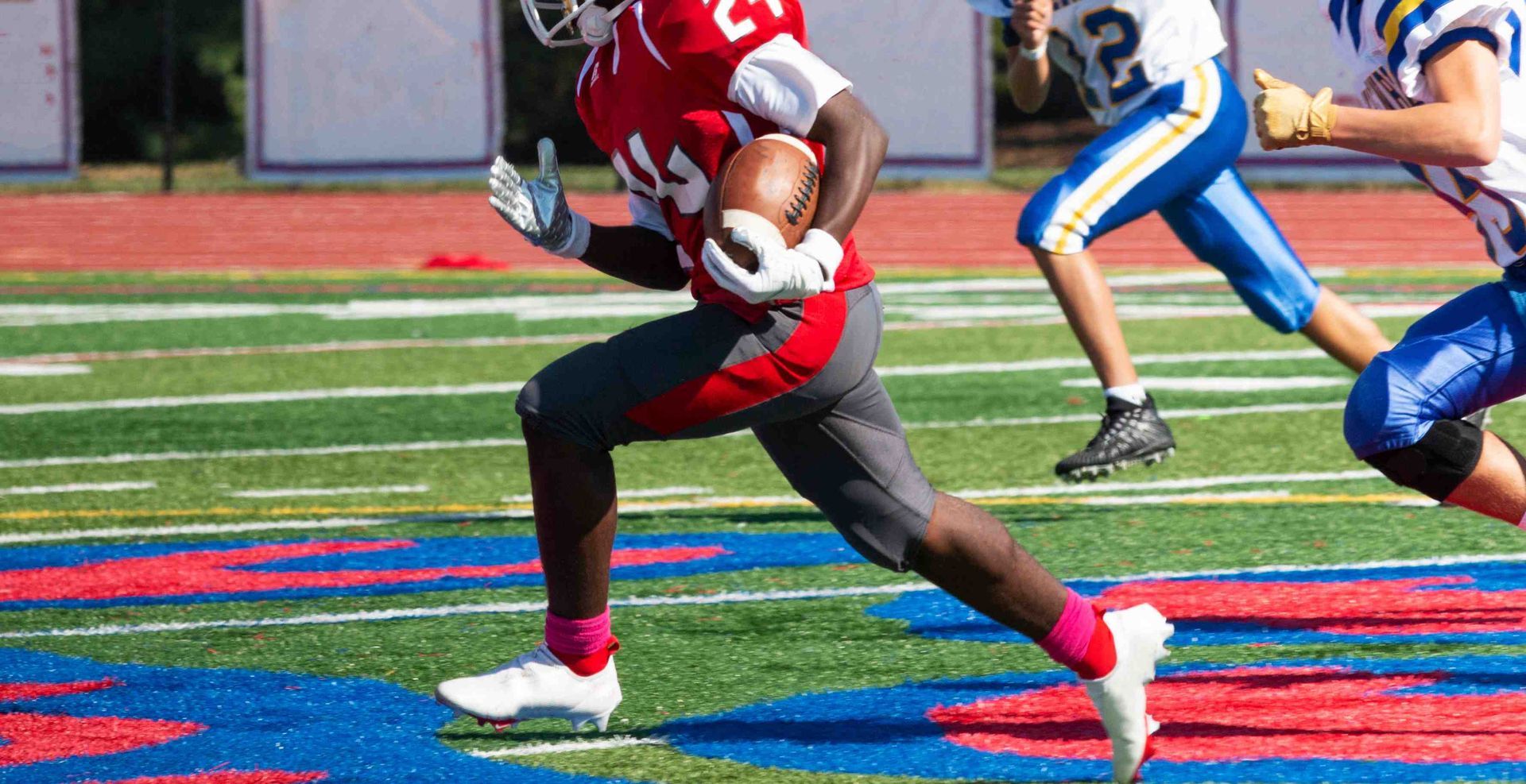 A live-action shot during a football game, mid-play