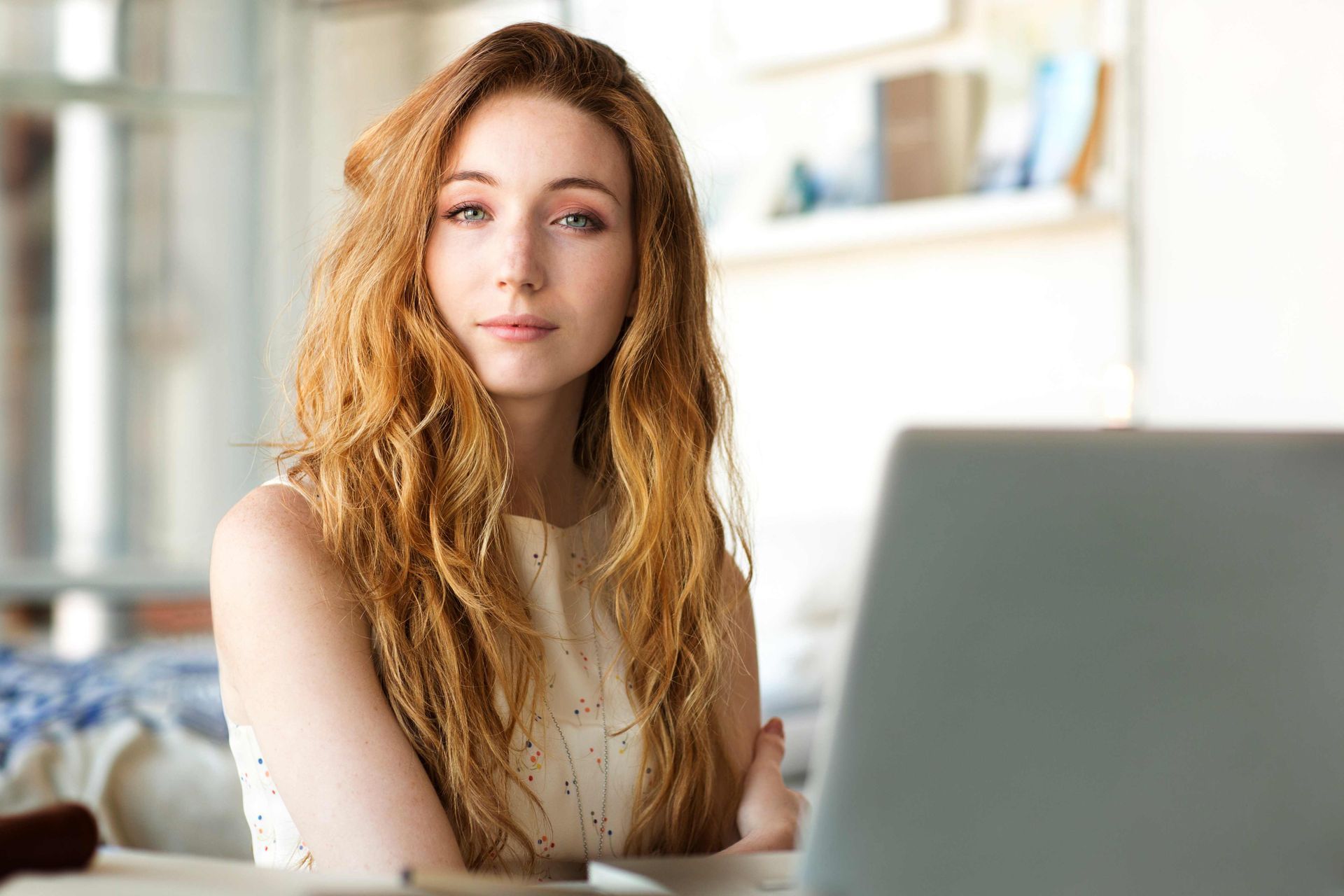 Headshot of woman in front of laptop