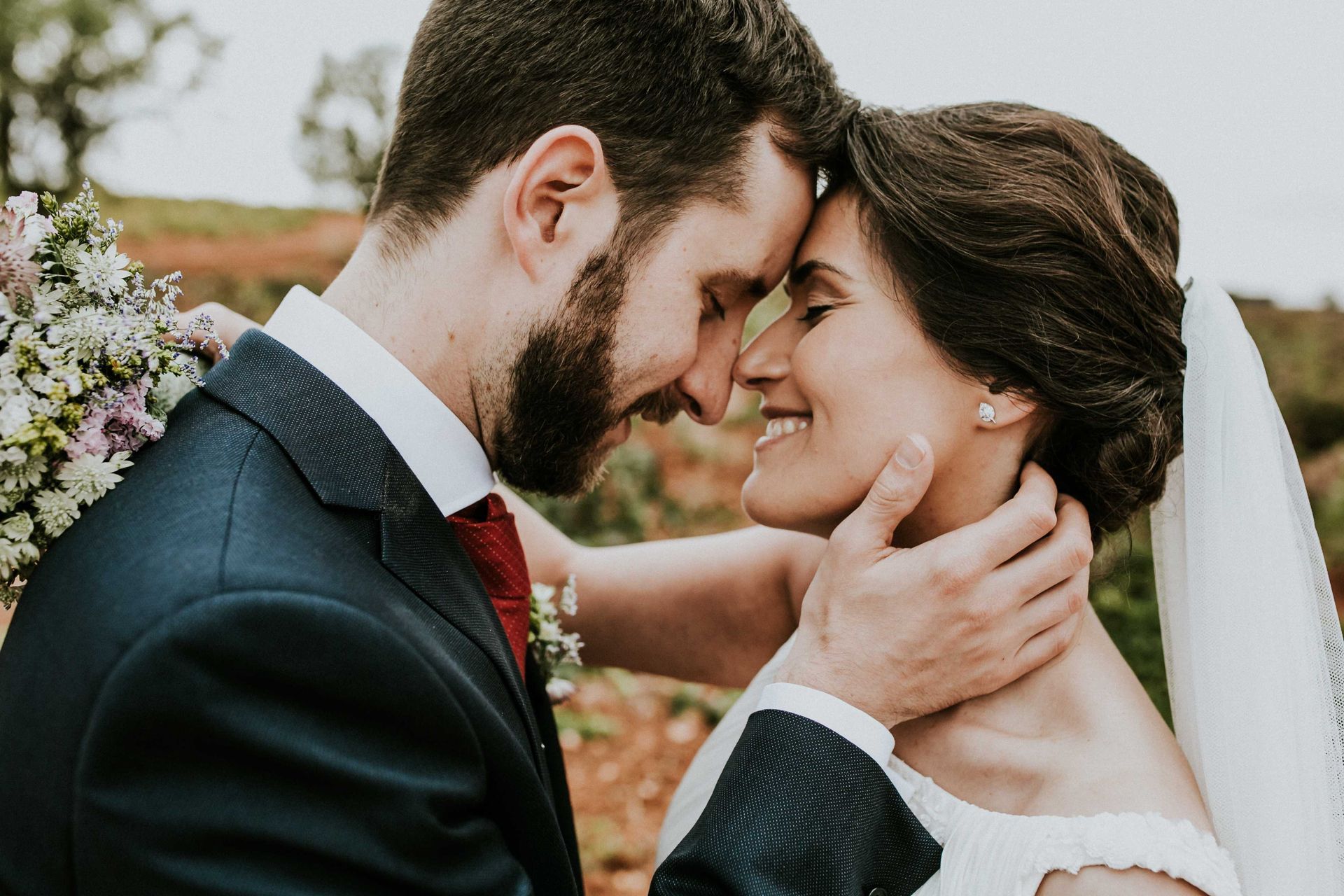 A bride and groom embracing with Texas backdrop