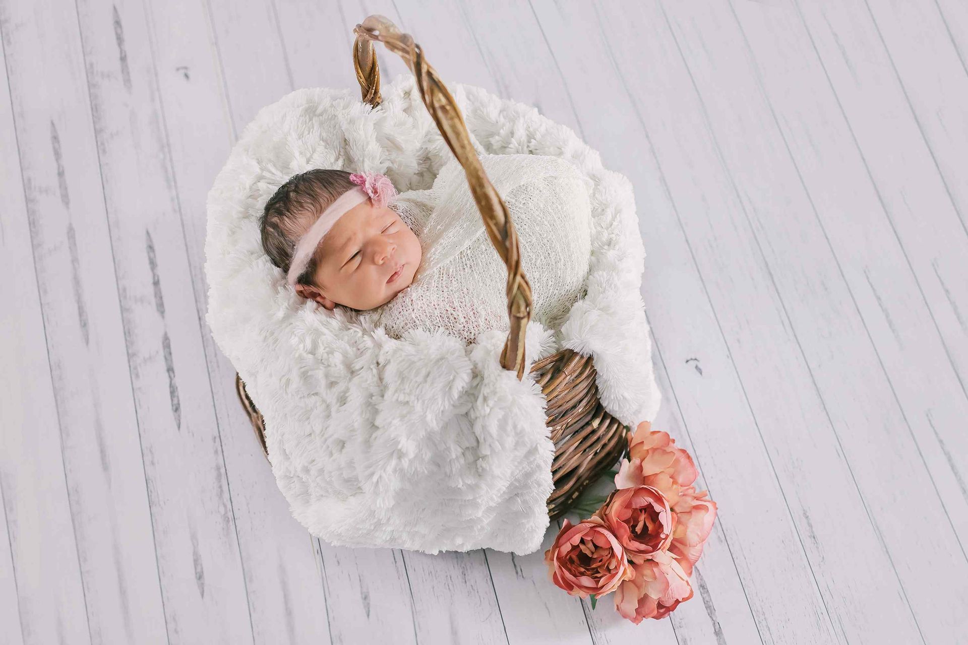 A baby beauty getting rest in a tiny bed with flowers