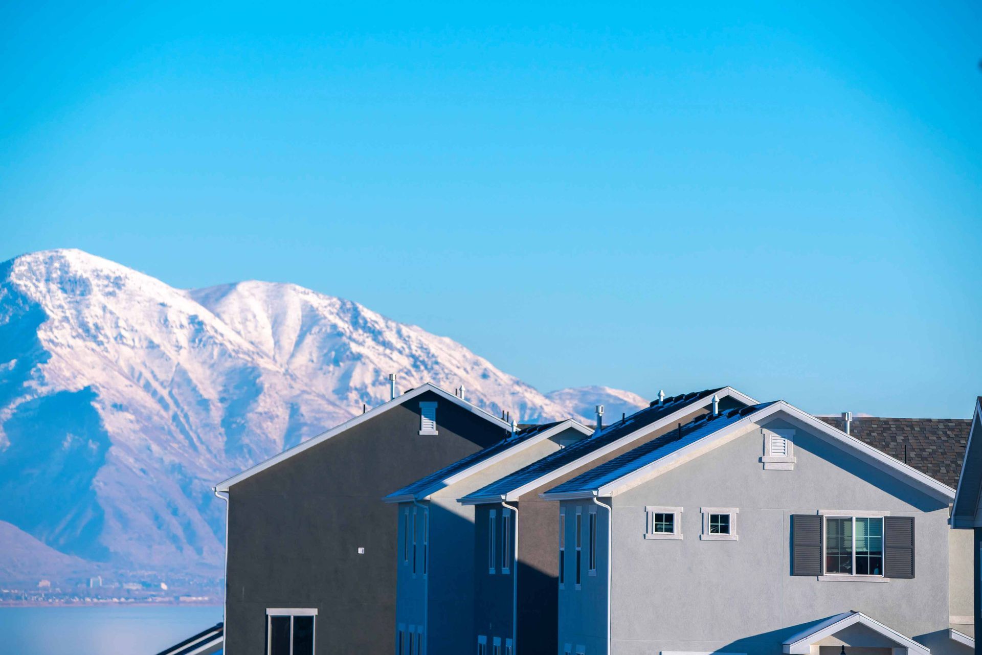 An exterior real estate photo with mountains in the background