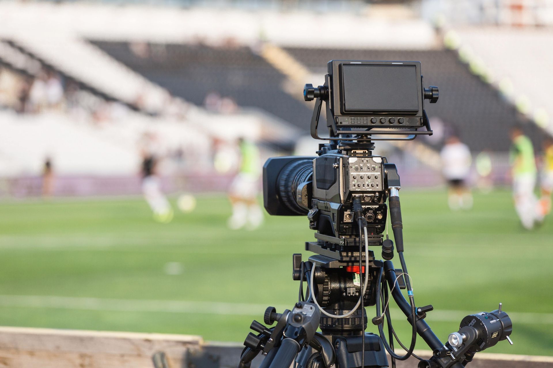 A photographer documenting a soccer game from stands