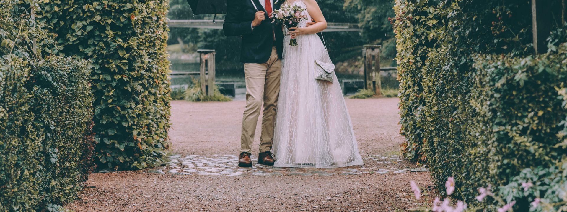 Image of a newlywed couple embracing outdoors
