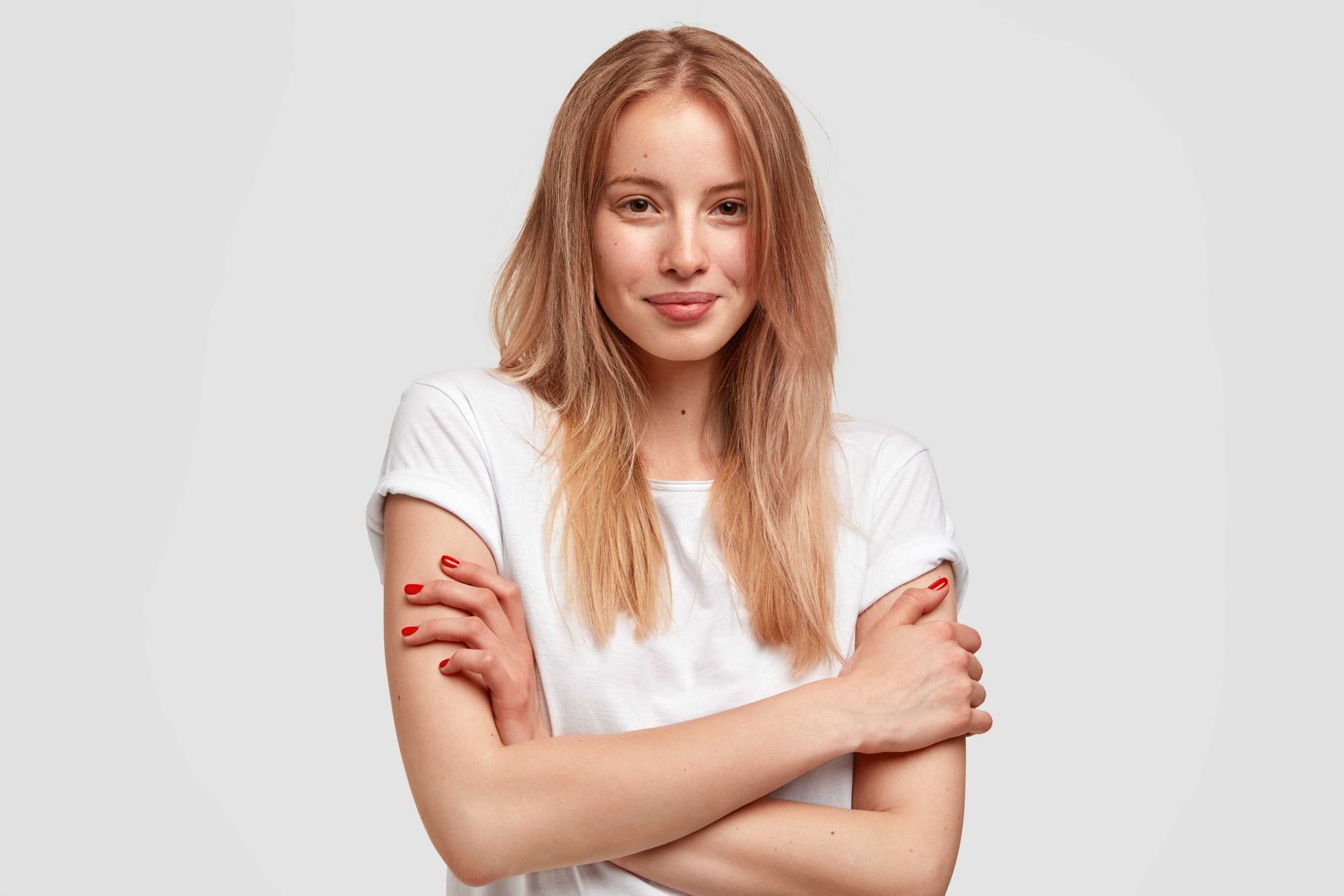 Photograph of a Texas woman in a white t-shirt folding her arms