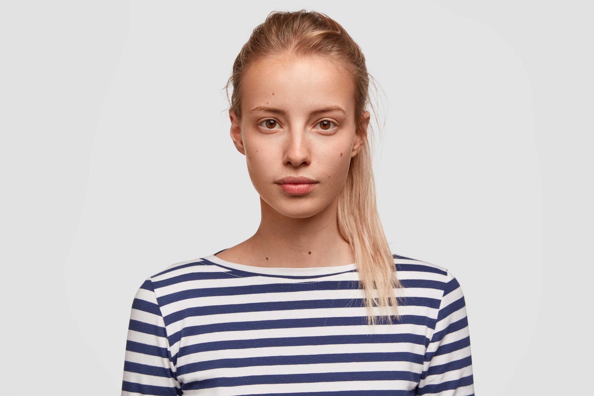 A woman in a ponytail and blue and white striped shirt from Lubbock, Texas