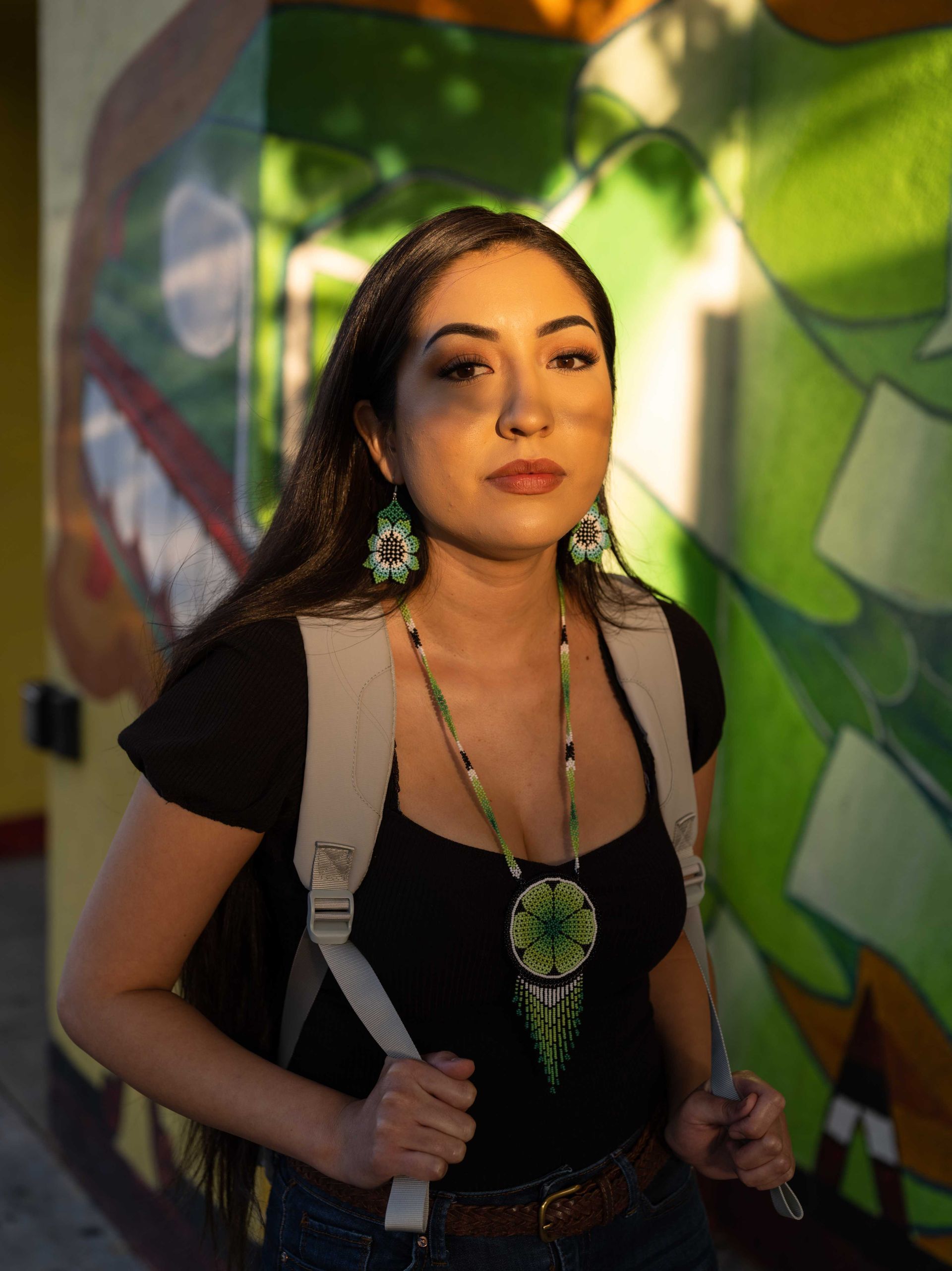 A woman in a professional jewelry photo with a cool necklace and earrings