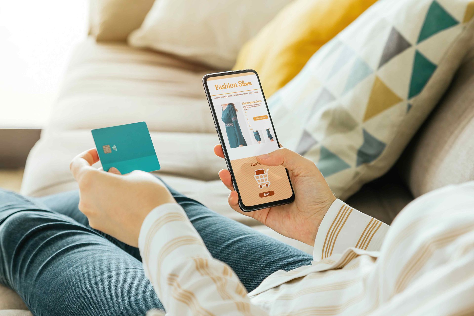 Woman engaging in e-commerce on her phone on the couch