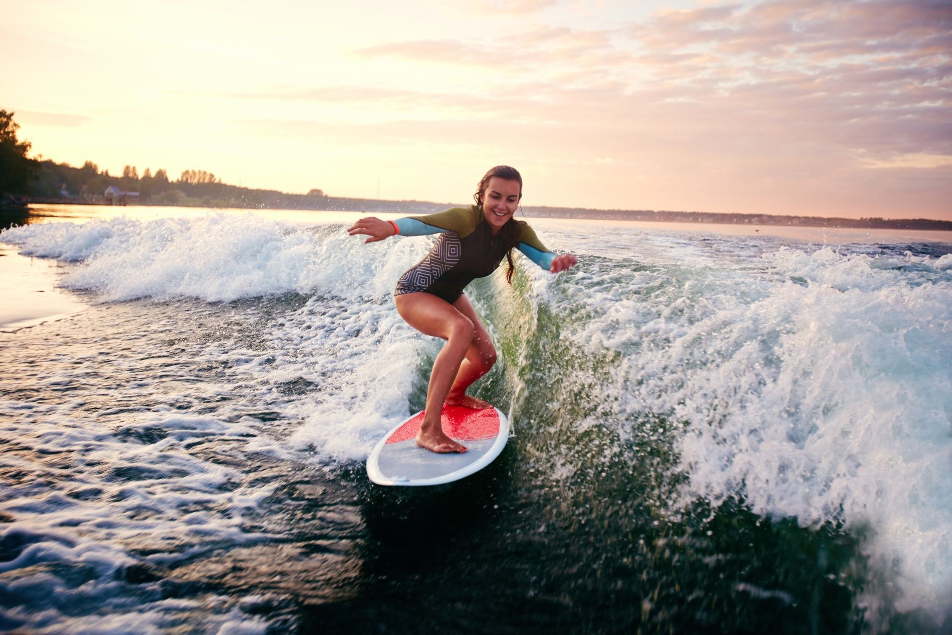 A woman is riding a wave on a surfboard in the ocean.