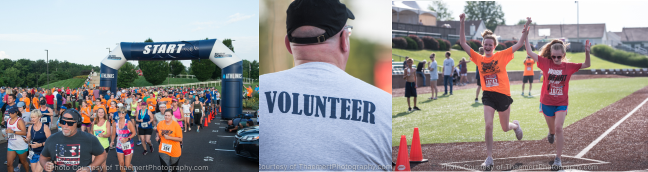 A man in a volunteer shirt is standing in front of a crowd of people.
