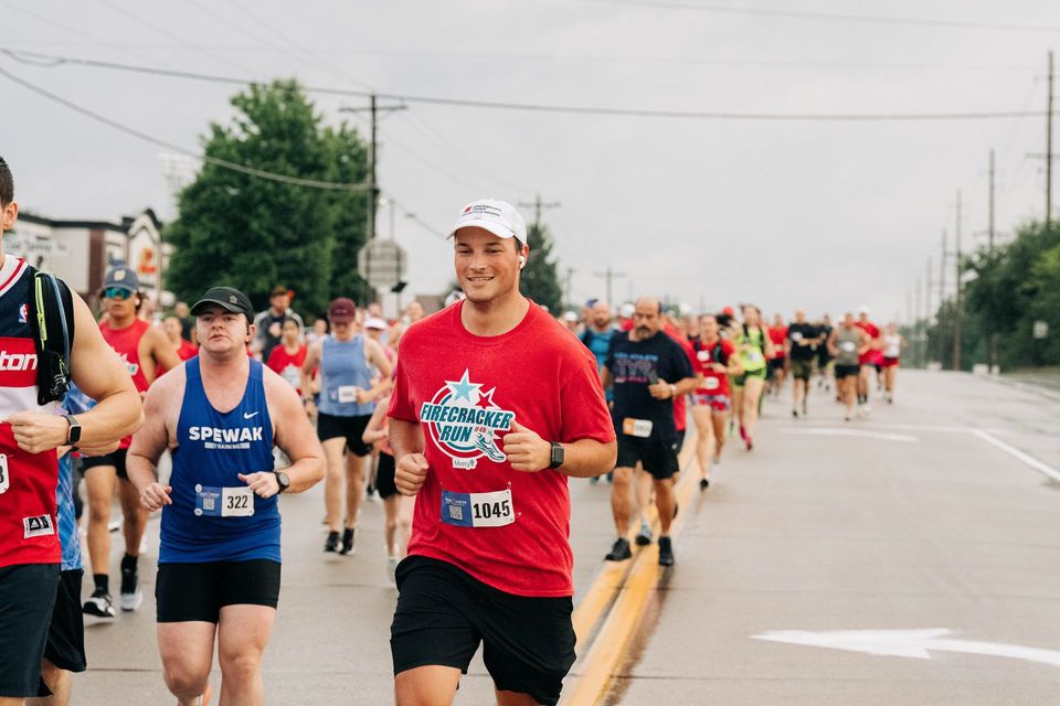 A group of people are running a marathon on a city street.