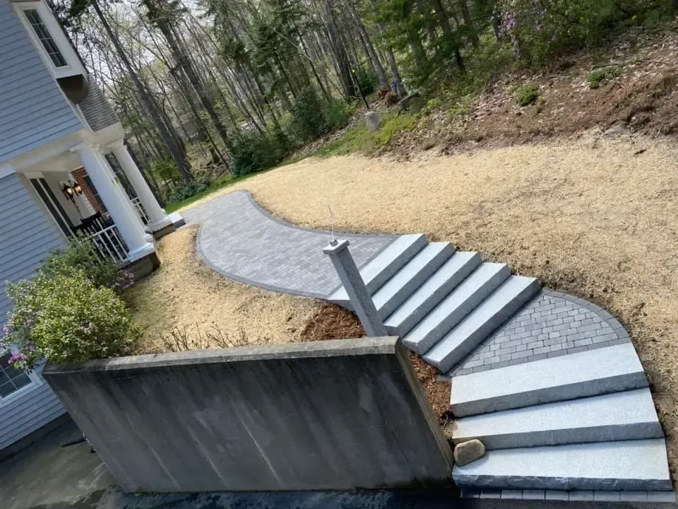 A walkway with stairs leading up to a house