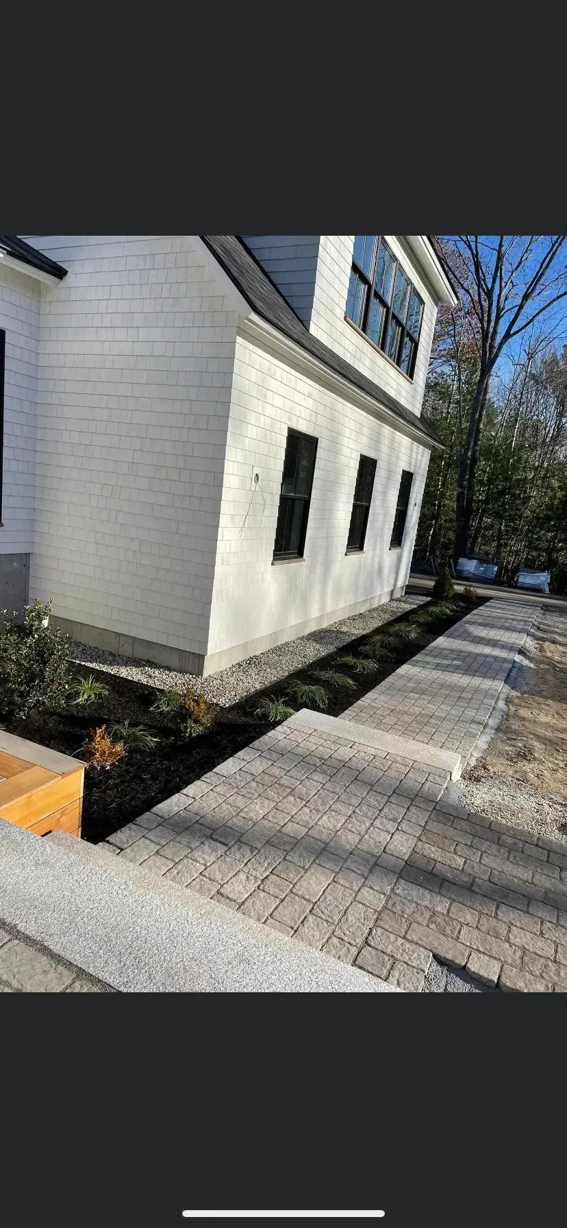 A white house with a walkway leading to it.