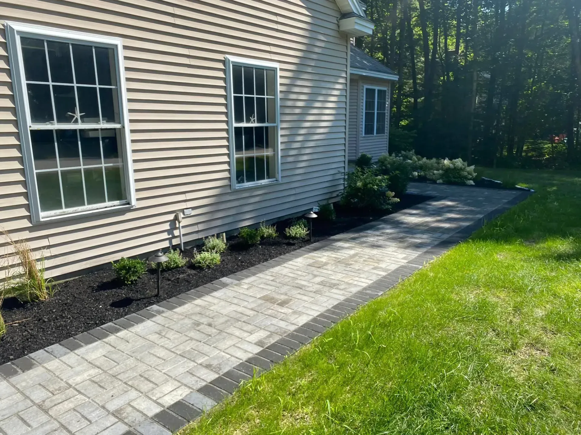 There is a walkway leading to the side of the house.
