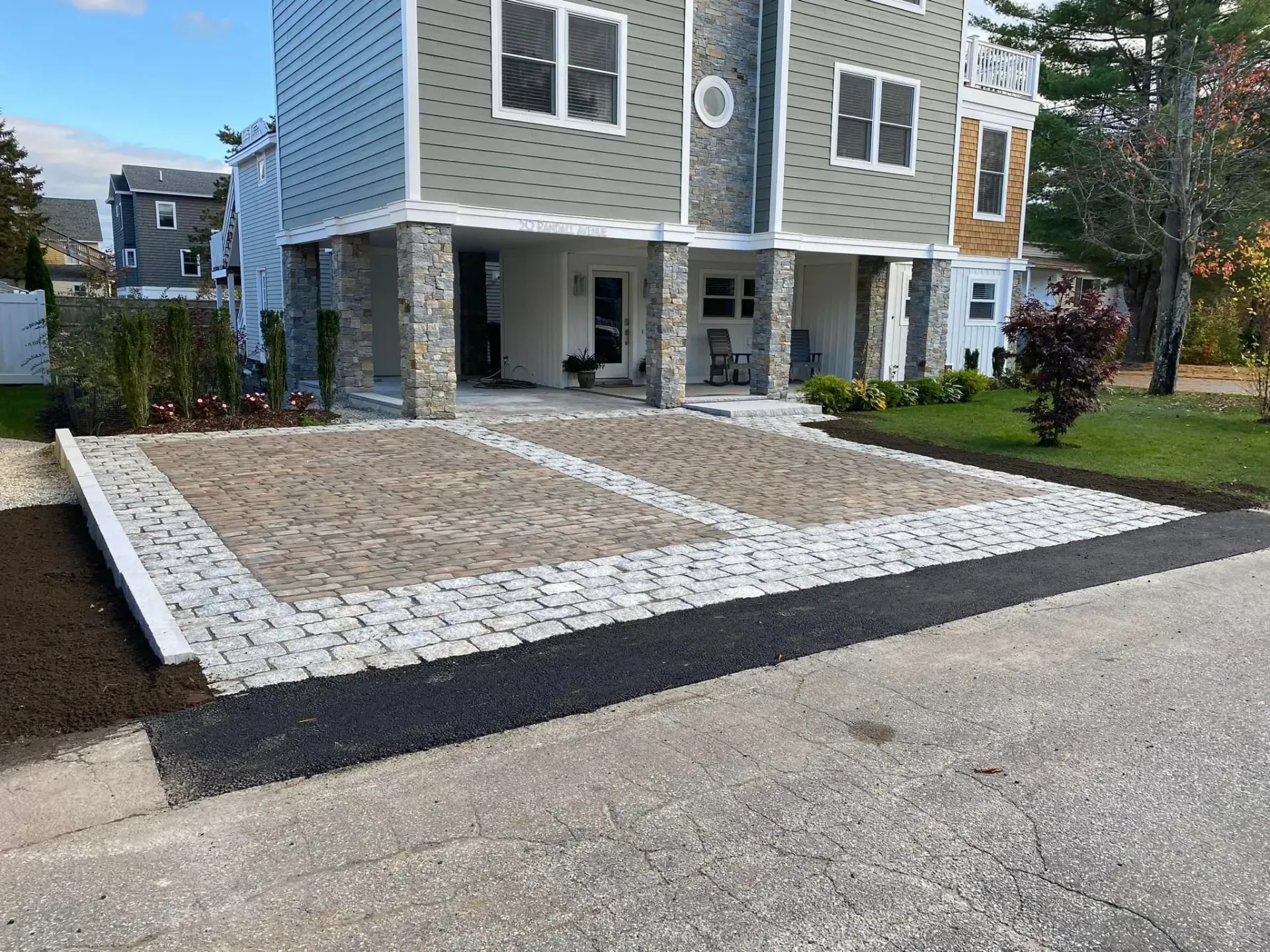A large house with a large driveway in front of it.