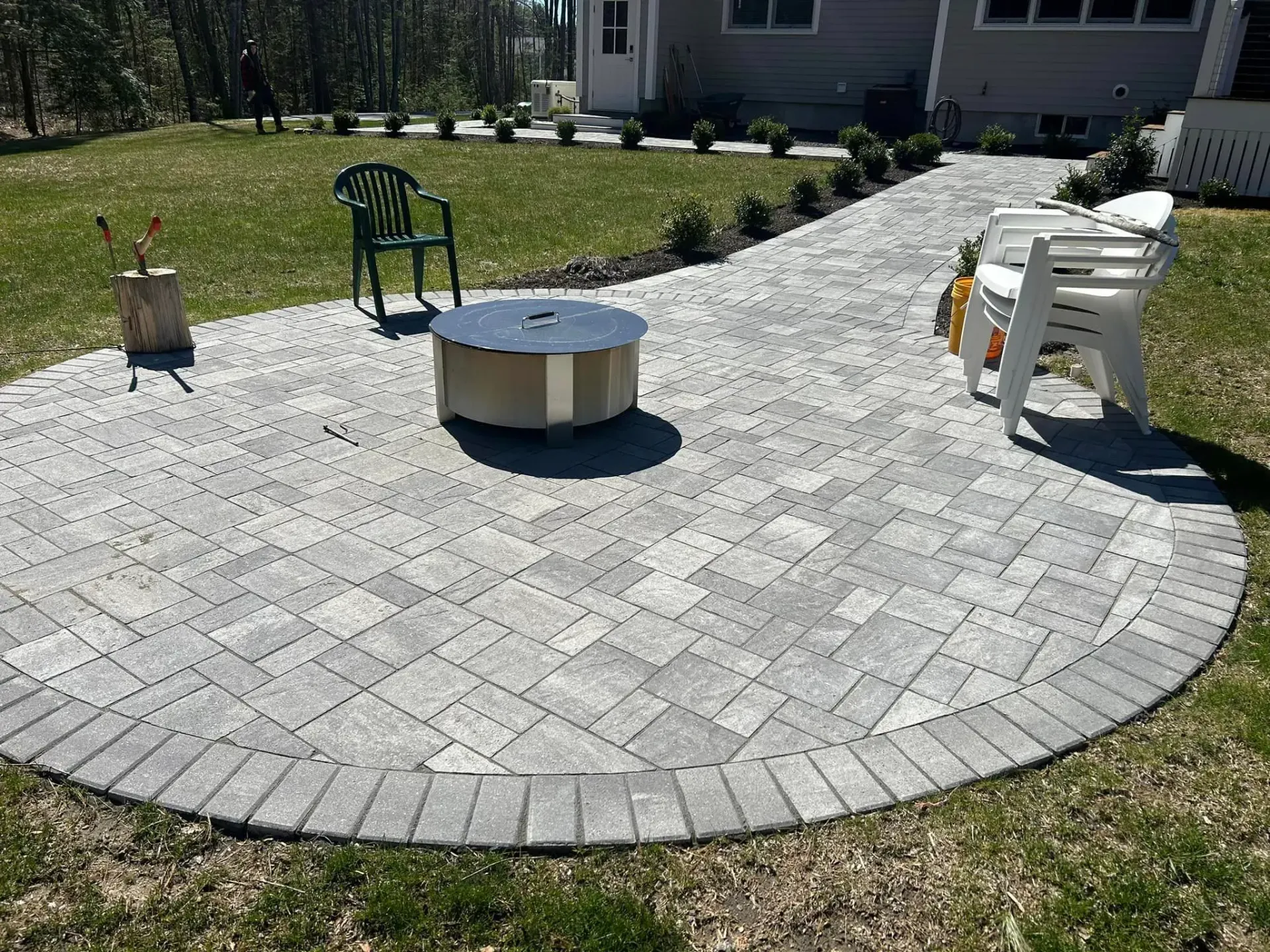 There is a fire pit in the middle of the patio.