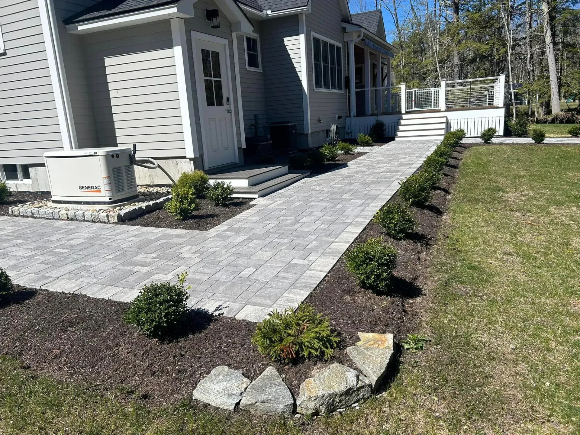 There is a walkway leading to the front of the house.
