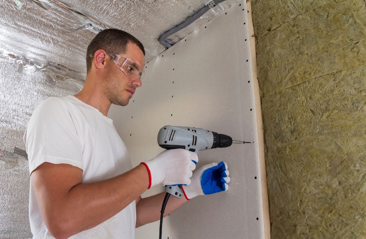 Drywall on wall beams, insulating rock wool staff in wooden frame. 