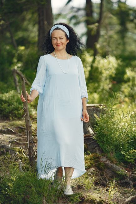 A smiling middle-aged woman walking outdoors